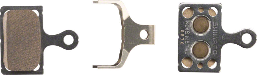 Pastillas de freno de disco Shimano K04S-MX con resortes y placa trasera de acero inoxidable y compuesto metálico.